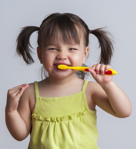 Child brushing teeth before children's dentistry checkup and teeth cleaning for kids