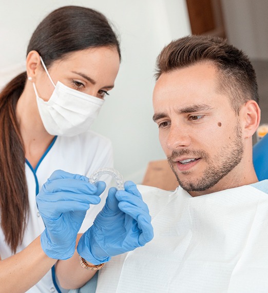 dentist explaining to a patient about Invisalign in Plano