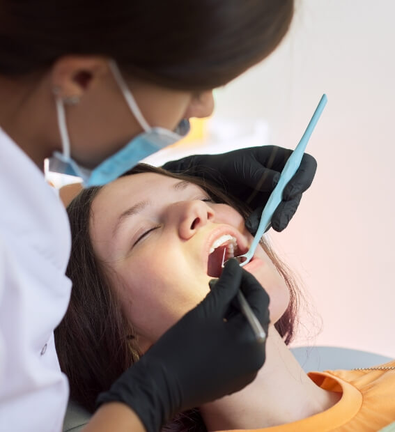 Dental patient receiving treatment with oral conscious sedation dentistry
