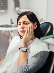 Woman in pain before restorative dentistry