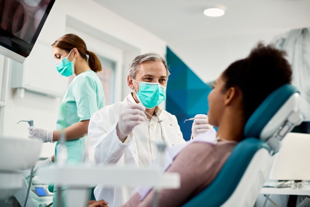 Dentist smiling at patient during dental checkup