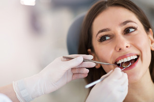 Woman having her teeth examined by the dentist